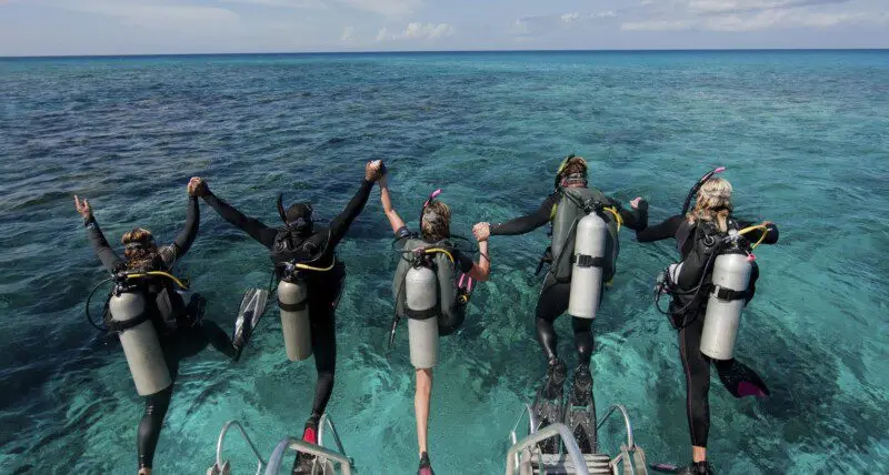 prep-for-scuba-season-divers-jumping-in-the-water