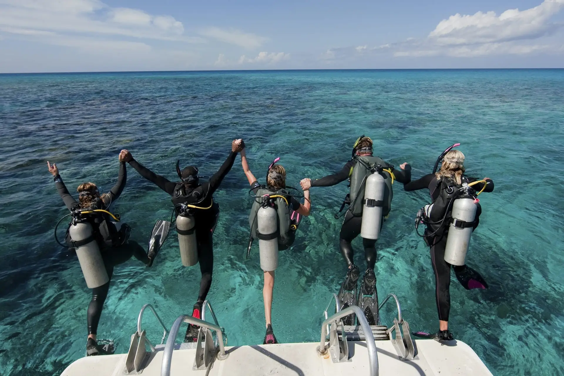 prep-for-scuba-season-divers-jumping-in-the-water